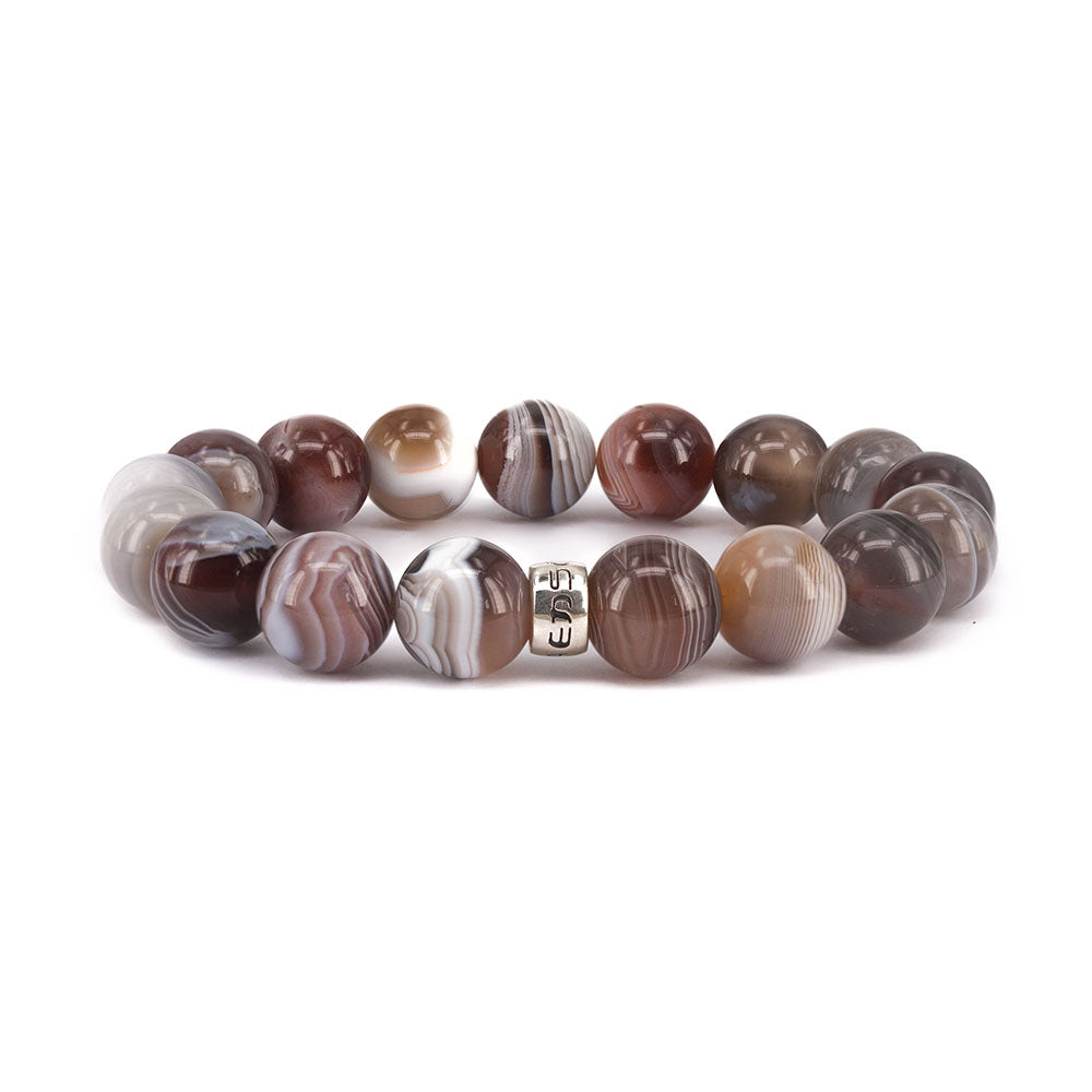 Victoriaenso's Botswana Agate is a luxurious and rare stone with distinctive white bands. Dating back nearly 200 million years, these agates offer balance and good fortune to its wearer.